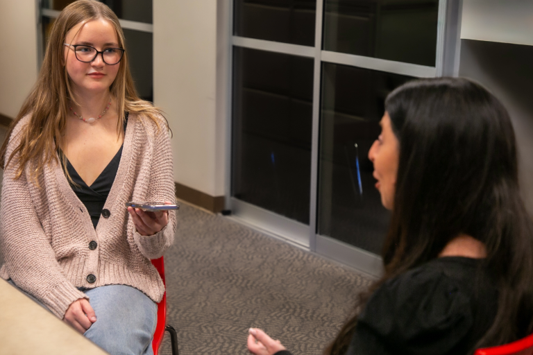 Woman records a person talking.